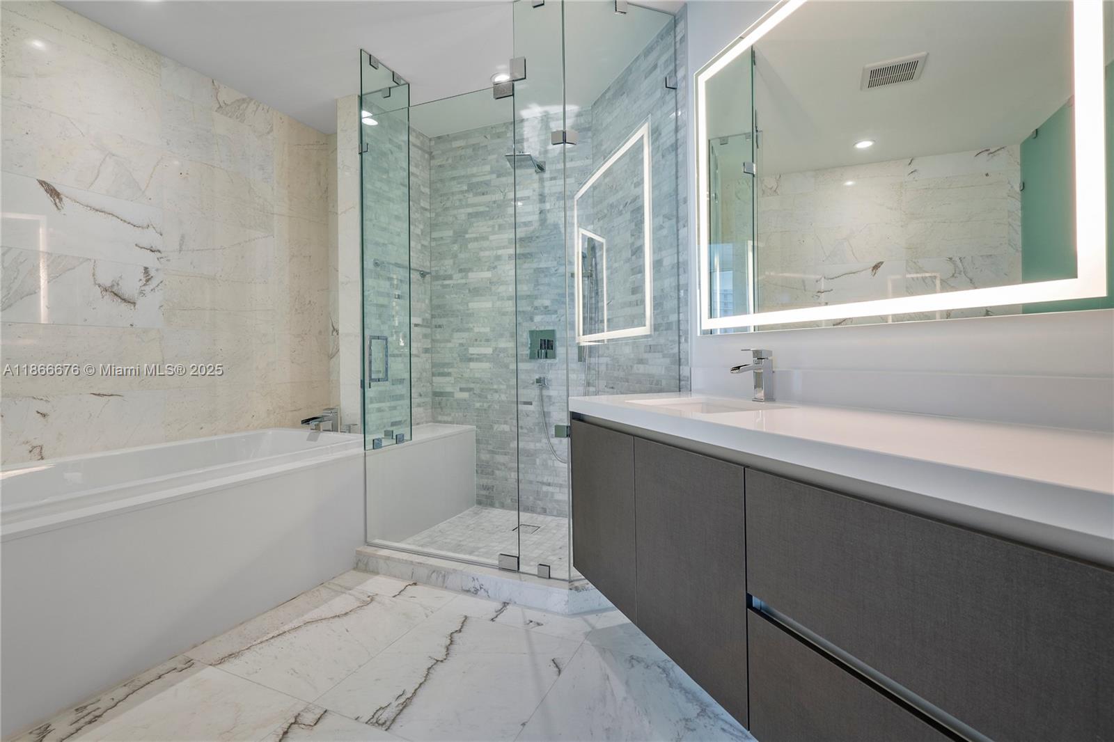 851 Northeast 1st Avenue, Unit 3203 Miami, FL 33132 - Photo 10 of 48 a bathroom with a bathtub and a sink