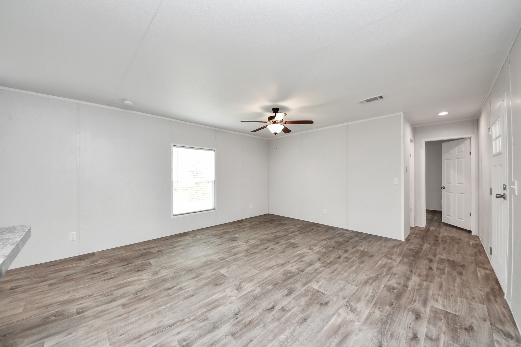 1560 Brown Road Willis, TX 77378 - Photo 14 of 28 wooden floor in an empty room with a window