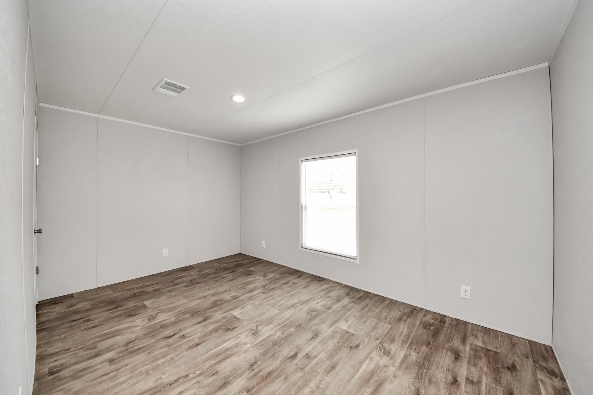 1560 Brown Road Willis, TX 77378 - Photo 15 of 28 an empty room with wooden floor and windows