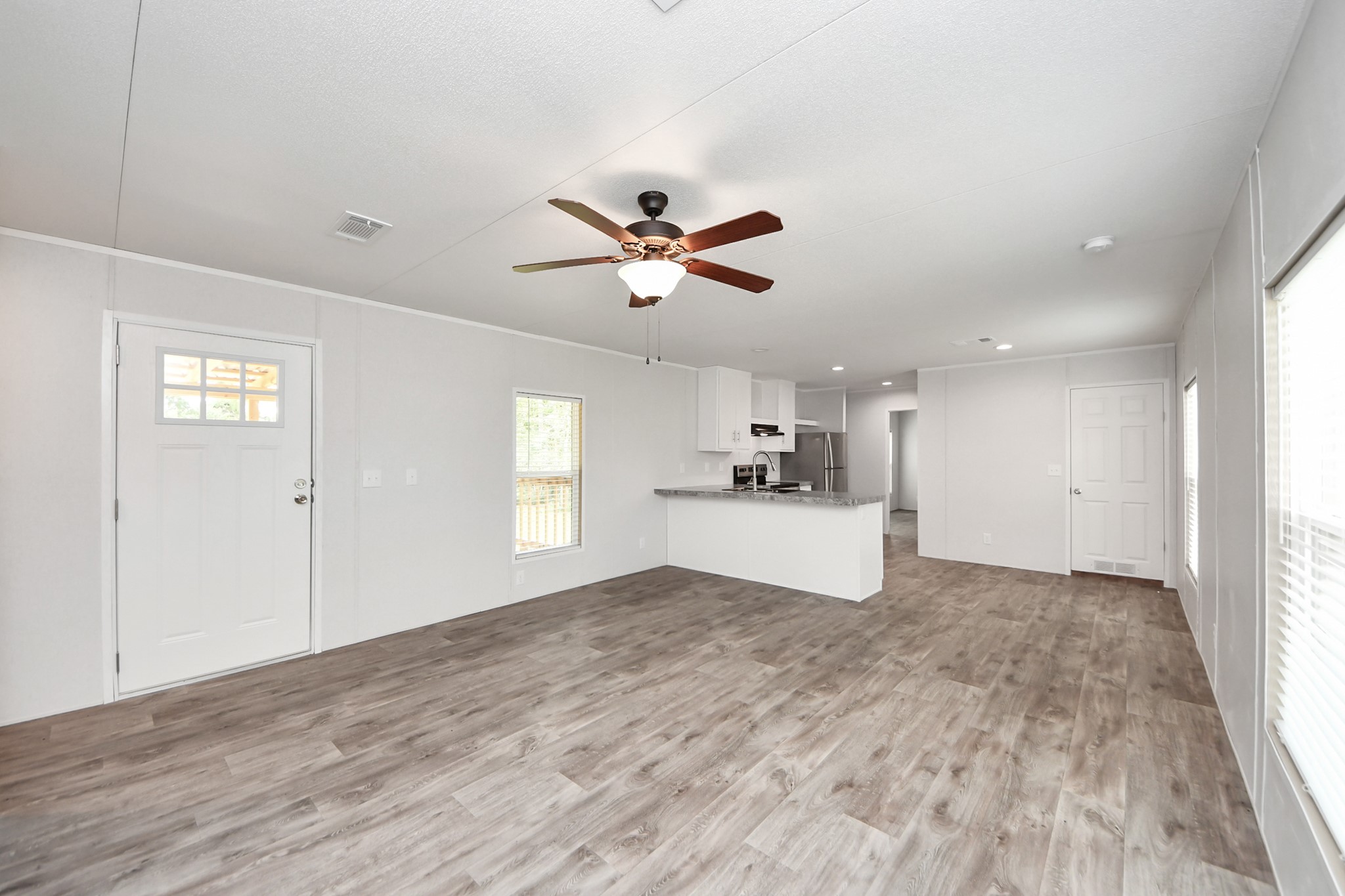 1560 Brown Road Willis, TX 77378 - Photo 7 of 28 a view of empty room with wooden floor and ceiling fan