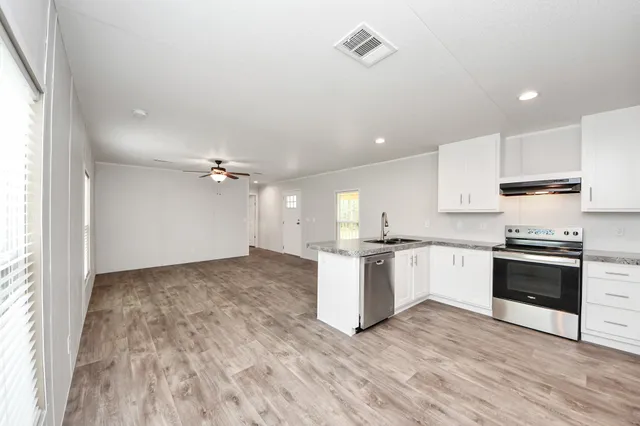 a kitchen with a stove a sink and a refrigerator