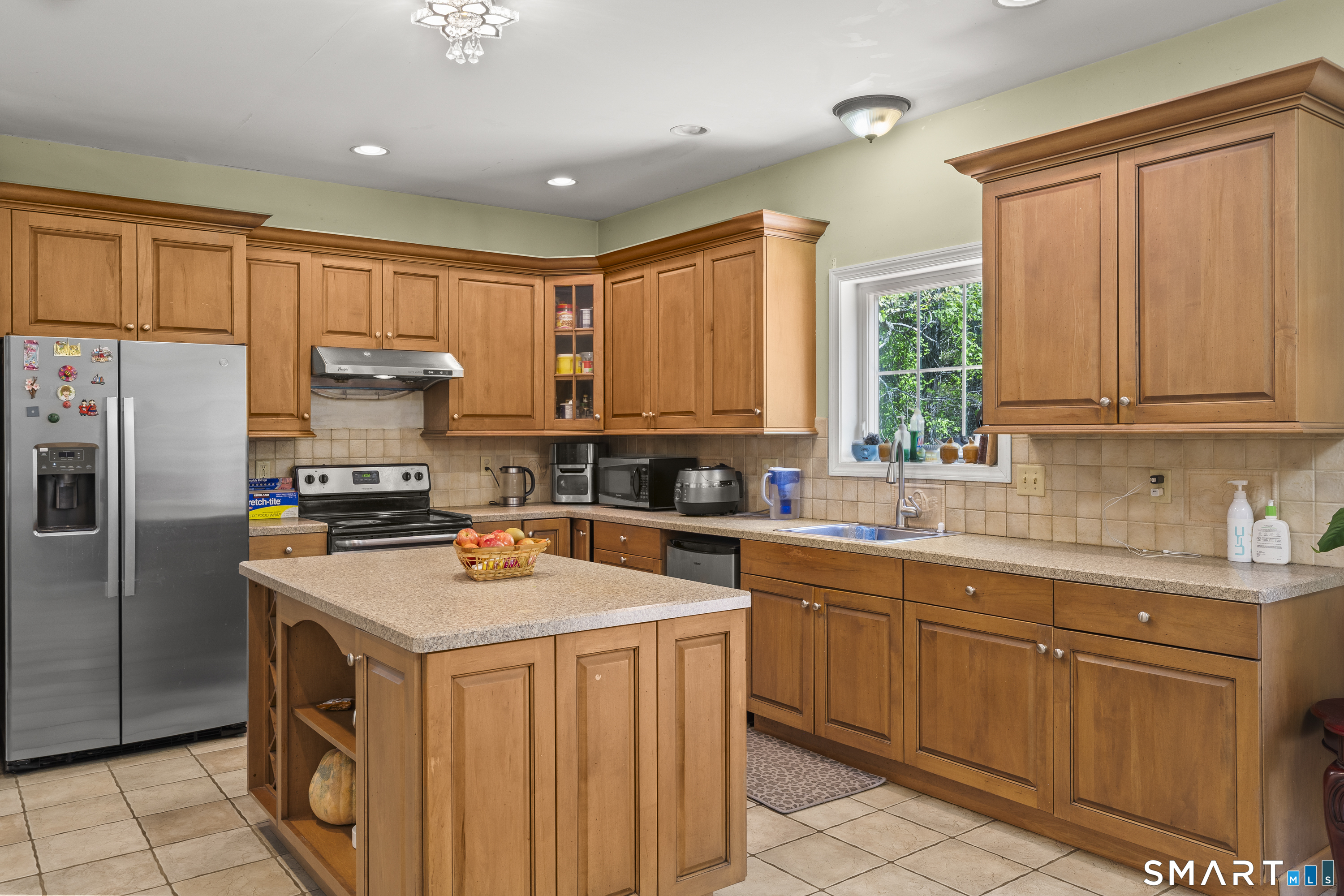 52 Middle Road Preston, CT 06365 - Photo 13 of 39 a kitchen with stainless steel appliances a stove a sink a refrigerator a center island and a window