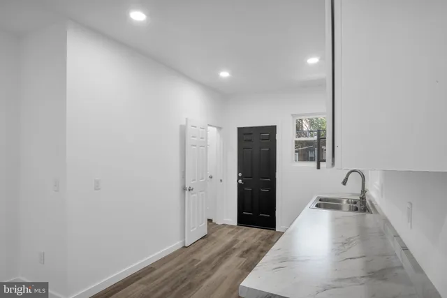 a kitchen with a sink and a stove top oven