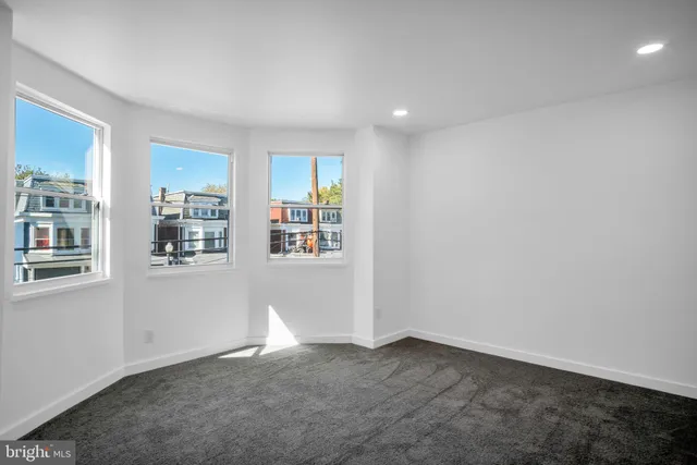 an empty room with closet and sliding door