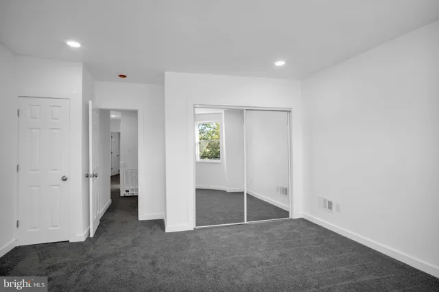 a bedroom with bed and wooden floor