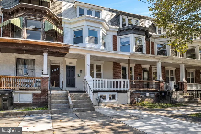a front view of a residential apartment building with a yard