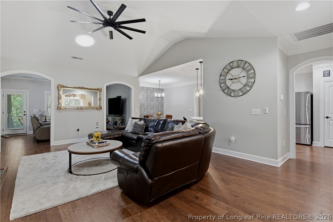 148 Heatherspring Way Spring Lake, NC 28390 - Photo 10 of 50 a living room with furniture a clock and a ceiling fan