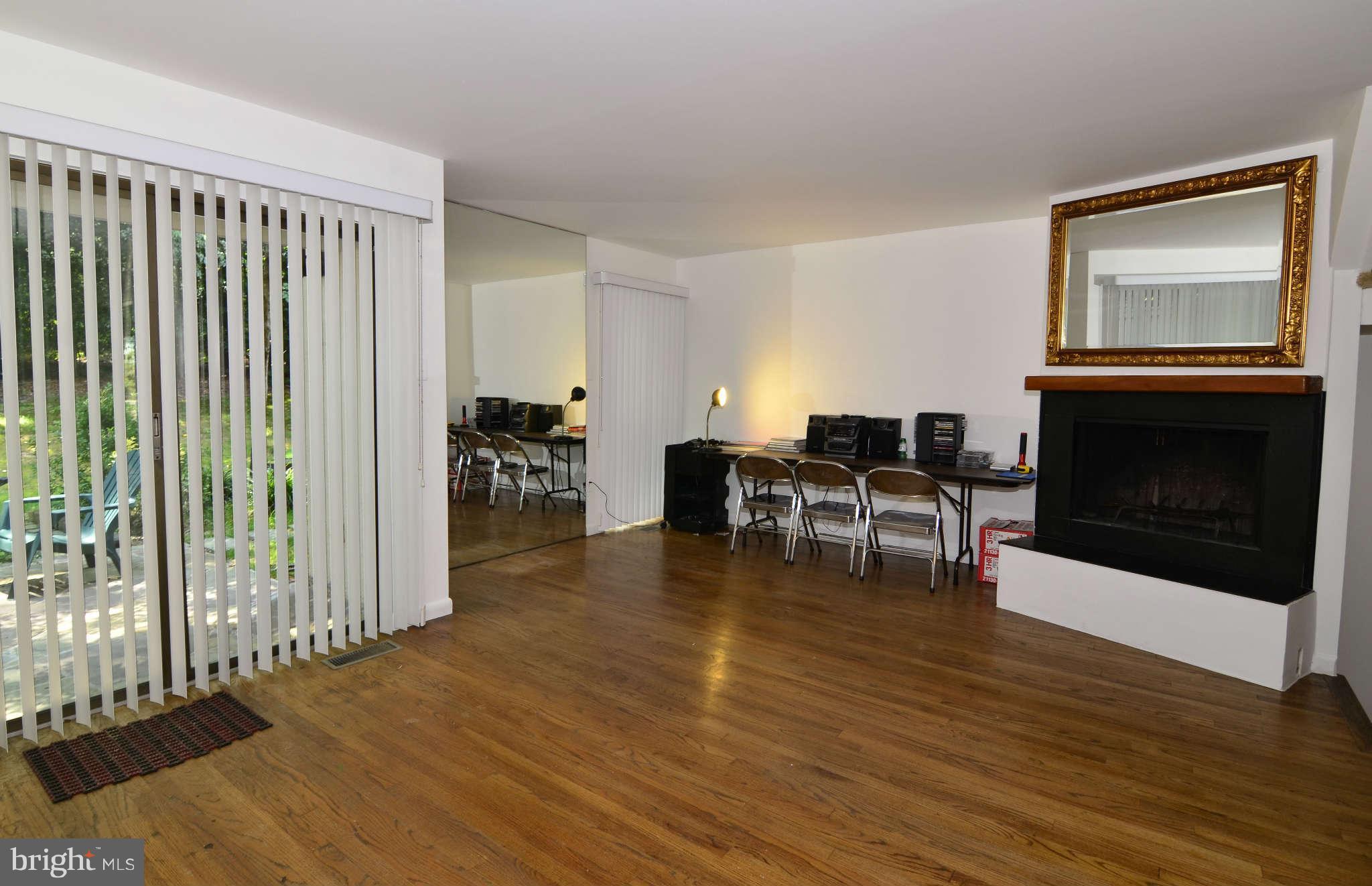 11703 Newbridge Court Reston, VA 20191 - Photo 5 of 25 Living room with wood burning fireplace