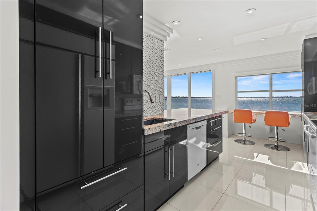 400 Golden Gate Point, Unit 11 Sarasota, FL 34236 - Photo 12 of 42 a kitchen with stainless steel appliances a refrigerator and a sink