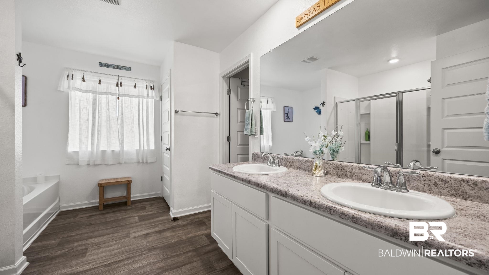 349 Hartenstein Road Foley, AL 36535 - Photo 25 of 32 Full bath with double vanity, a stall shower, dark wood finished floors, and a garden tub