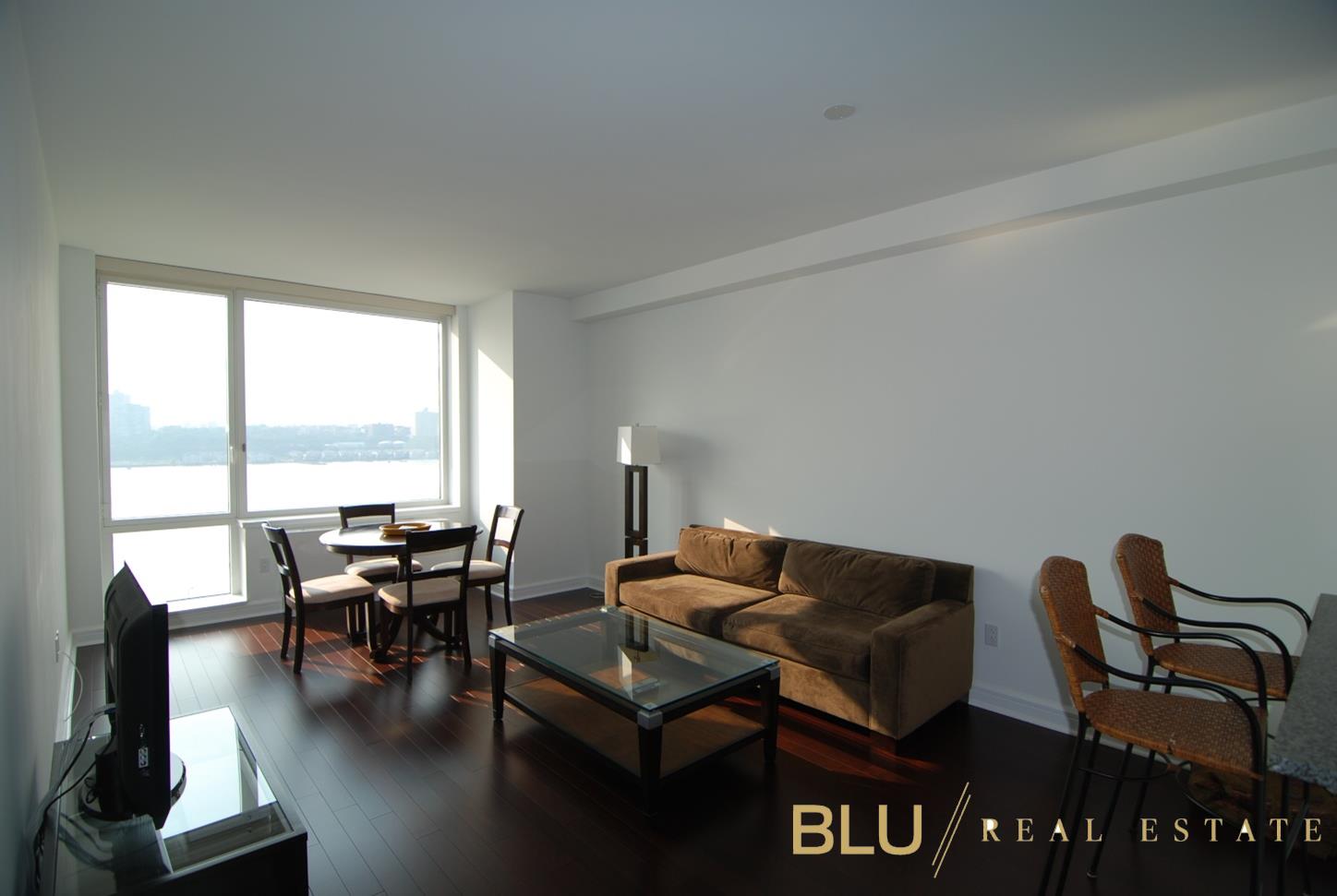 100 Riverside Boulevard, Unit 16E Manhattan, NY 10069 - Photo 1 of 11 a living room with furniture and floor to ceiling windows