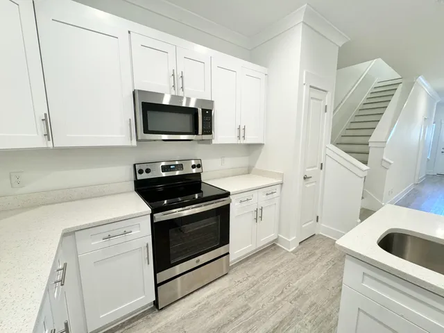 a kitchen with a sink and a stove top oven