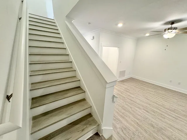 a view of a hallway with wooden floor