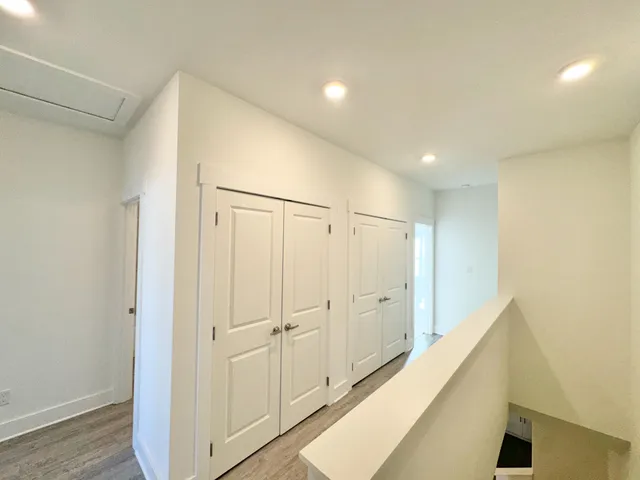a view of a hallway with wooden floor
