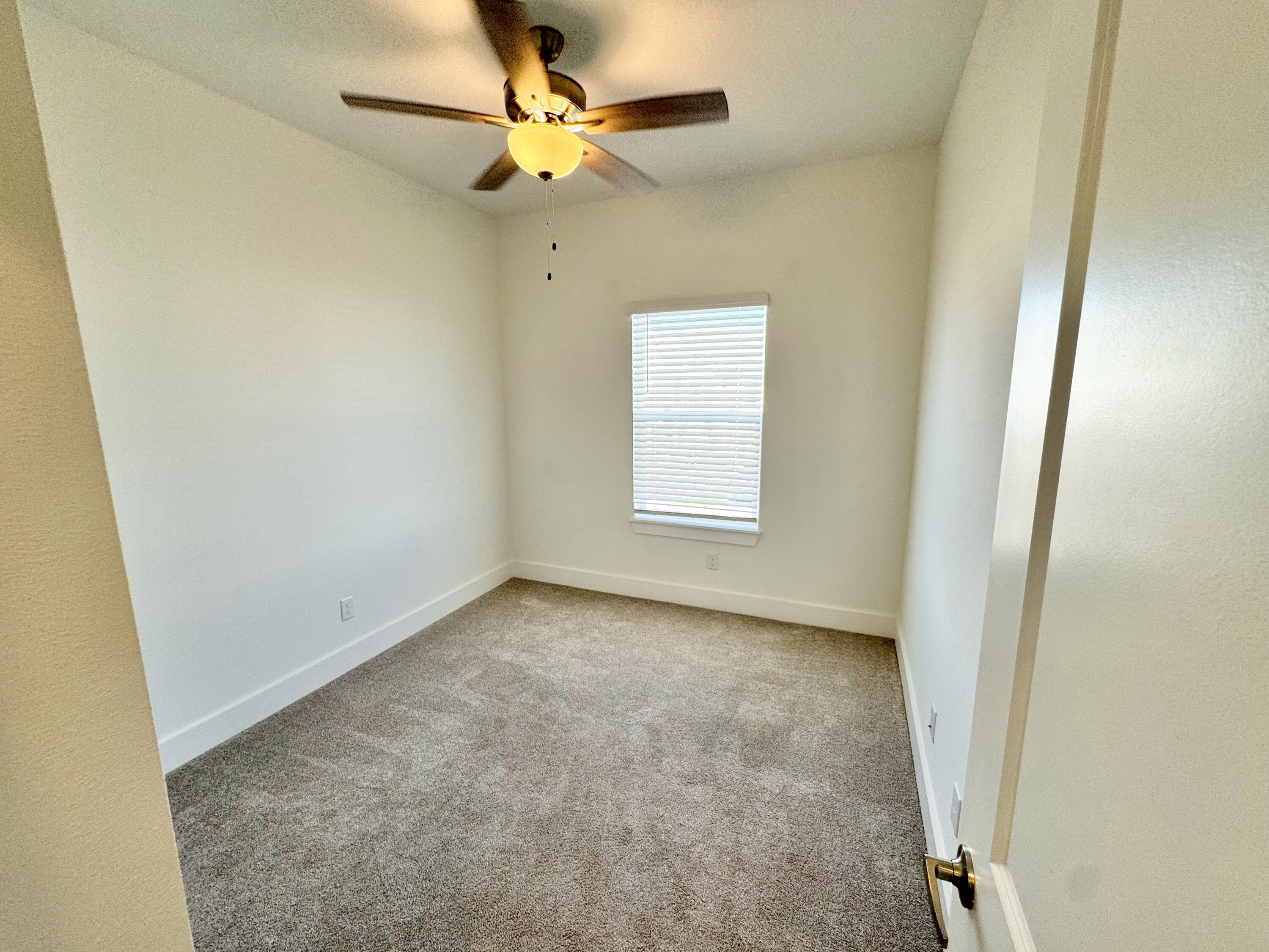 103 Date Palm Lane Freeport, FL 32439 - Photo 23 of 33 an empty room with a window and a fan