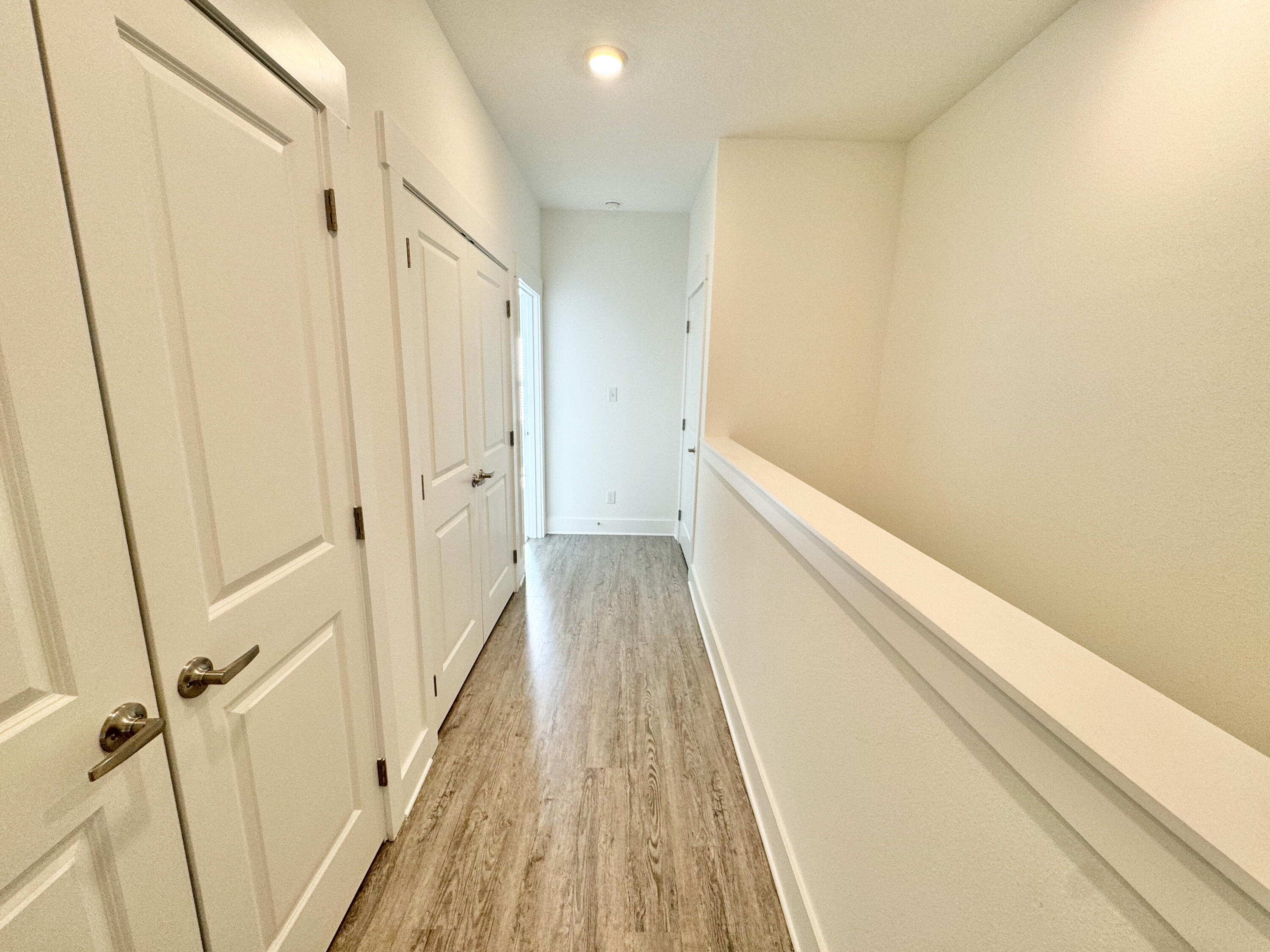 103 Date Palm Lane Freeport, FL 32439 - Photo 28 of 33 a view of a hallway with wooden floor and staircase