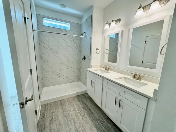a bathroom with 2 sink and a mirror