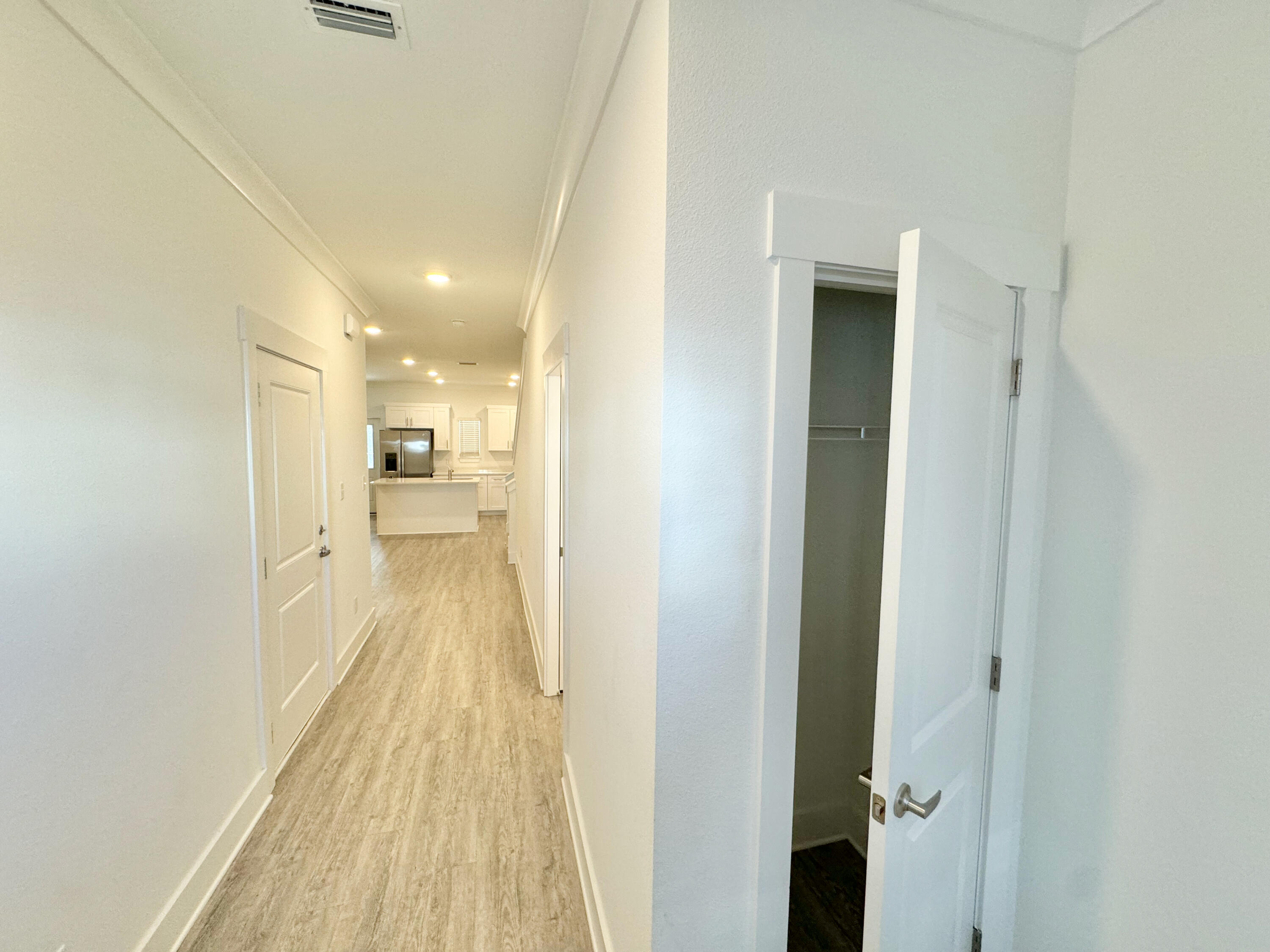 103 Date Palm Lane Freeport, FL 32439 - Photo 5 of 33 a view of a hallway with a wooden floor