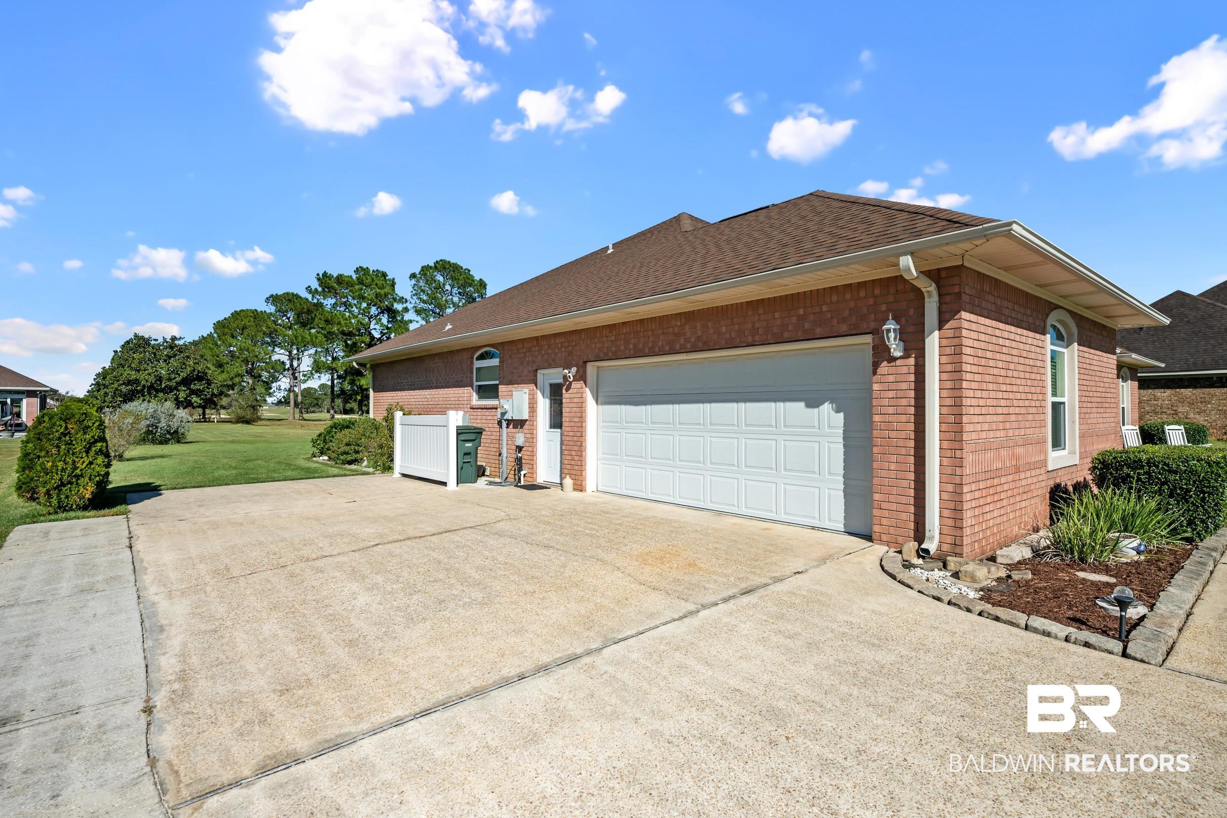 22355 East County Road 12 Foley, AL 36535 - Photo 51 of 54 View of side of home featuring driveway, brick siding, a garage, a yard, and a shingled roof