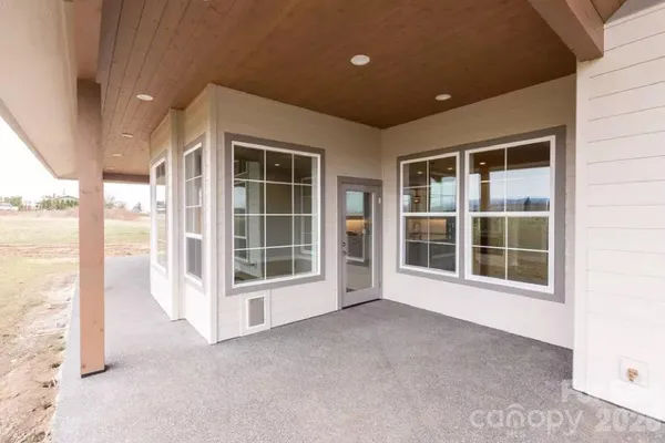 a view of an empty room with a window and balcony