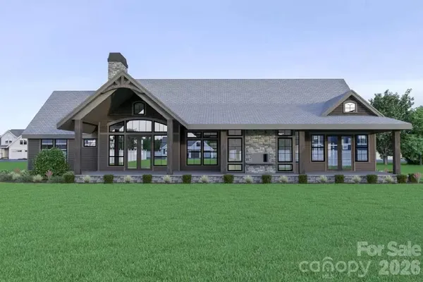a front view of a house with a garden and trees