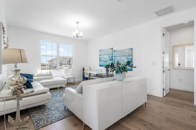 a living room with furniture and a chandelier