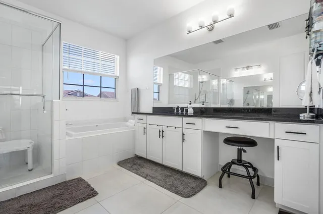 a bathroom with a granite countertop sink a toilet and shower