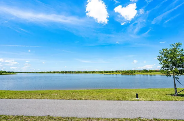a living room with lots of furniture and view of kitchen