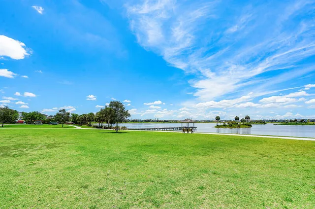 a dining area with stainless steel appliances kitchen island a table and chairs
