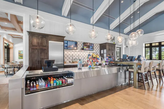 a living room with furniture a dining table and a large window