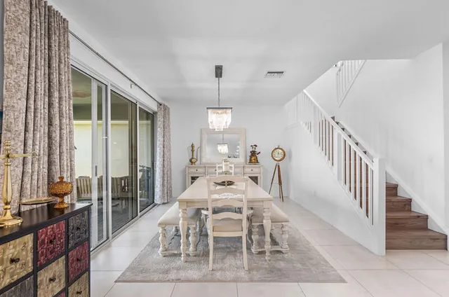 a dining room with a table and chairs