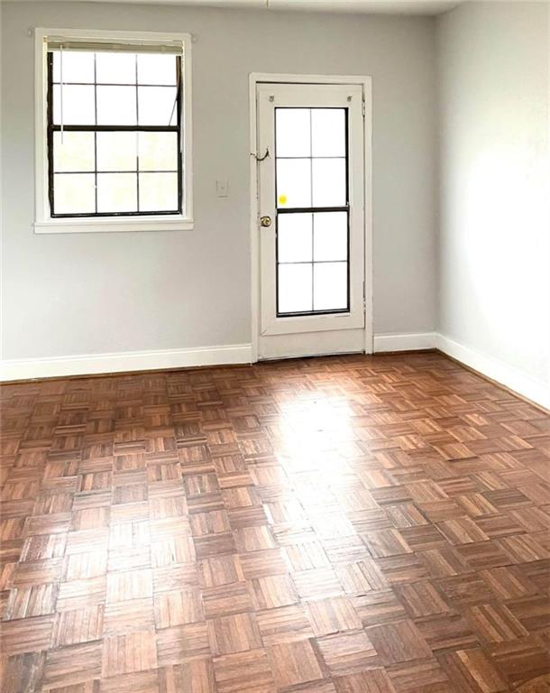 1443 Oxford Road Northeast, Unit 2 Atlanta, GA 30307 - Photo 4 of 7 an empty room with windows