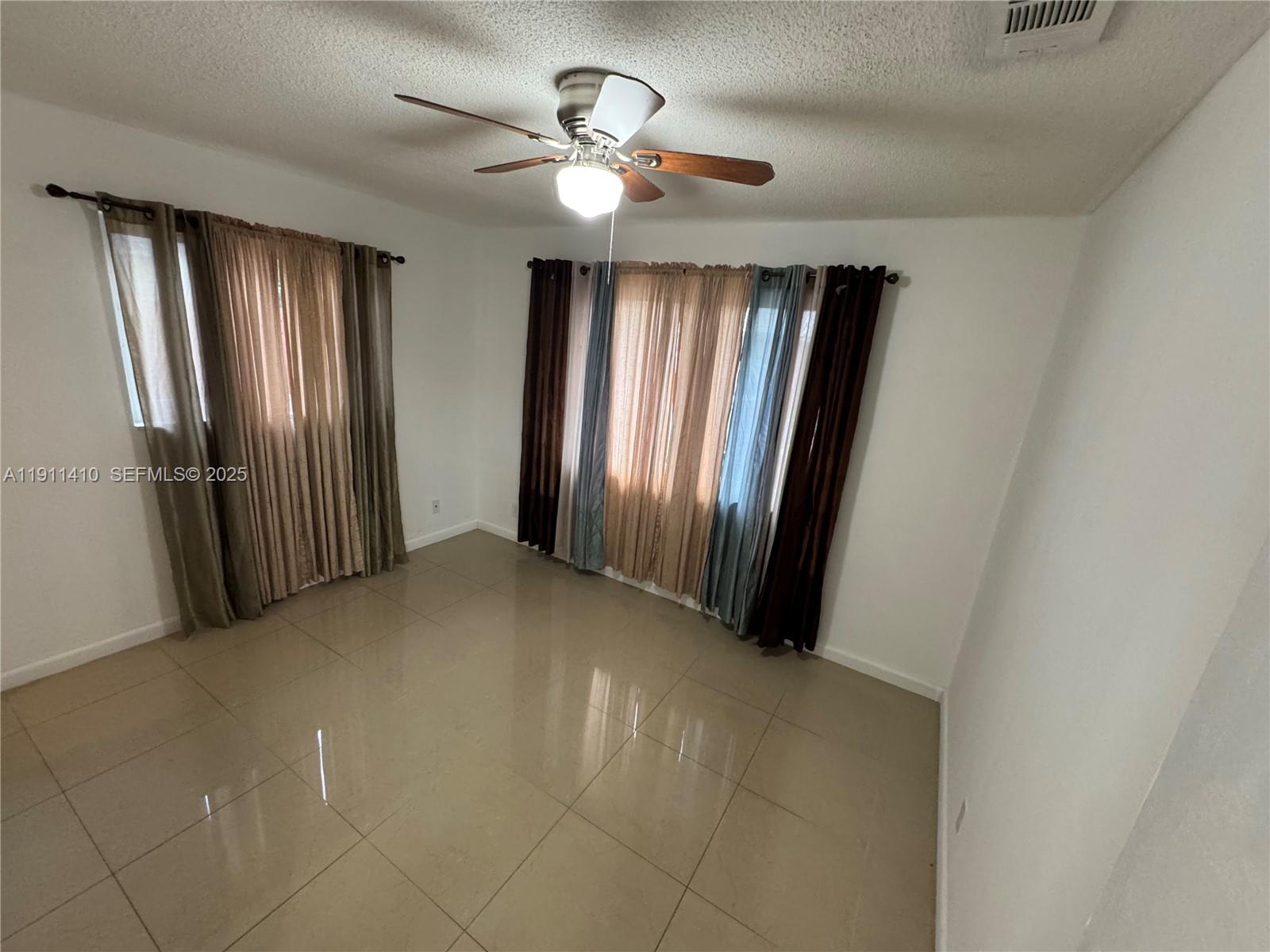 4578 Northwest 16th Avenue, Unit 4578 Tamarac, FL 33309 - Photo 11 of 24 an empty room with windows and closet