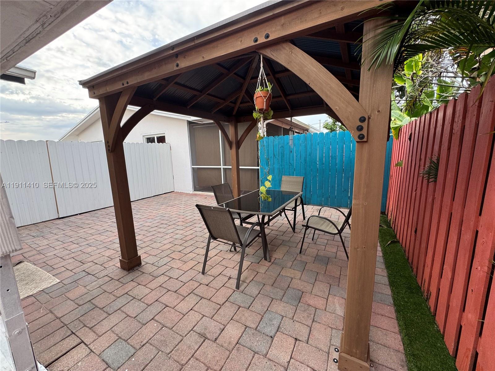 4578 Northwest 16th Avenue, Unit 4578 Tamarac, FL 33309 - Photo 19 of 24 a patio with table and chairs