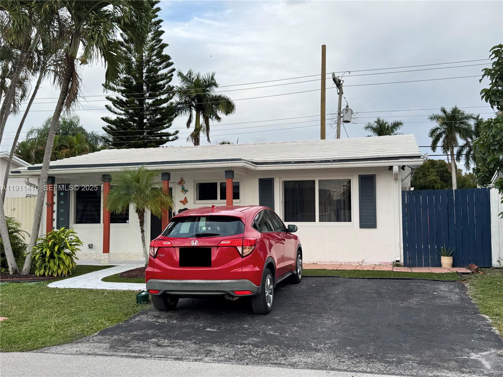 4578 Northwest 16th Avenue, Unit 4578 Tamarac, FL 33309 - Photo 2 of 24 a front view of a house with garden