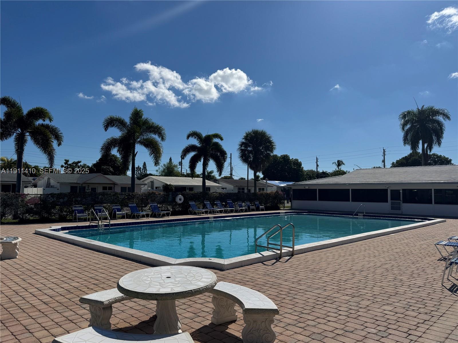 4578 Northwest 16th Avenue, Unit 4578 Tamarac, FL 33309 - Photo 22 of 24 a view of a swimming pool with a patio