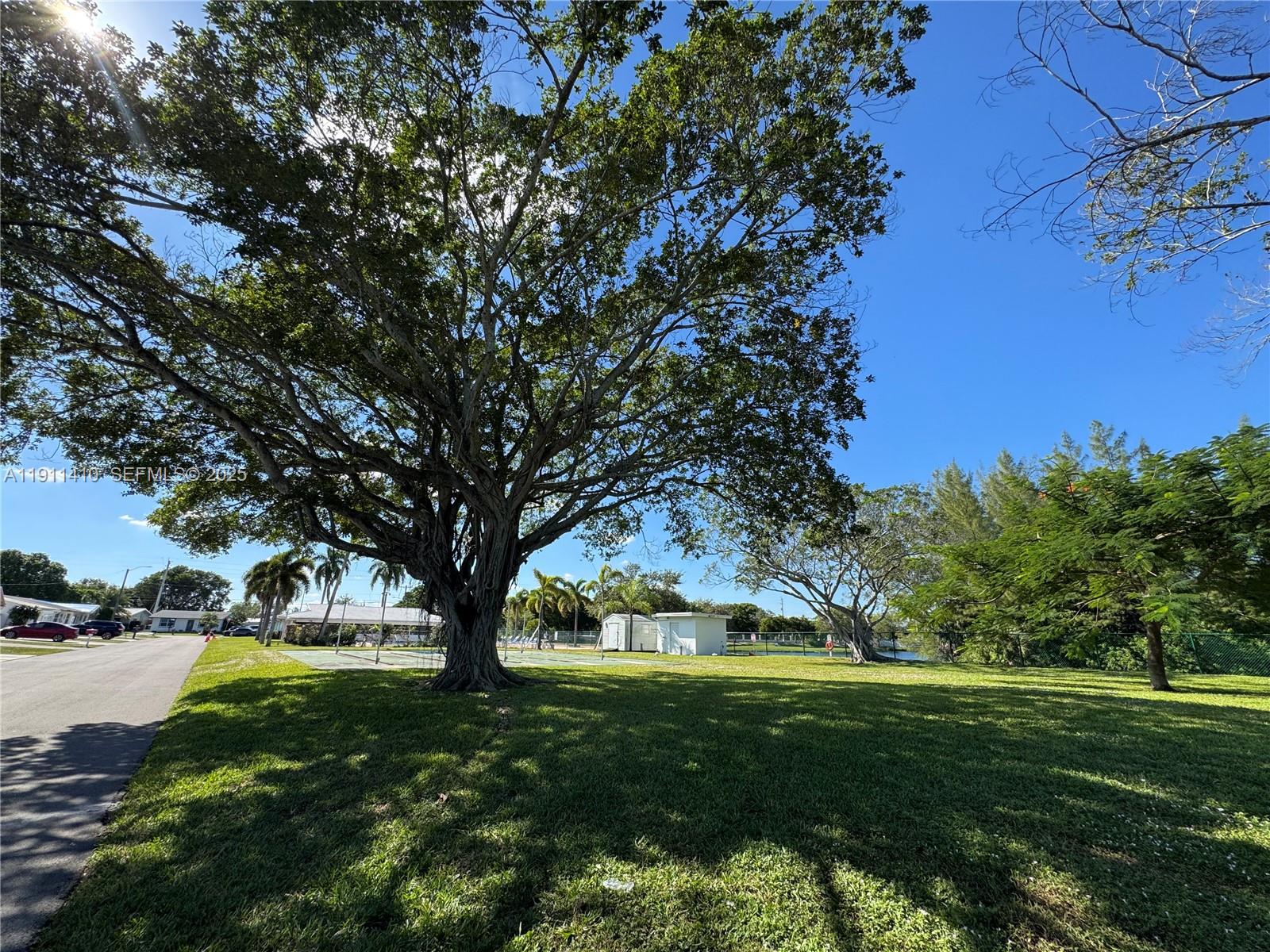4578 Northwest 16th Avenue, Unit 4578 Tamarac, FL 33309 - Photo 23 of 24 a big yard with lots of green space and fountain