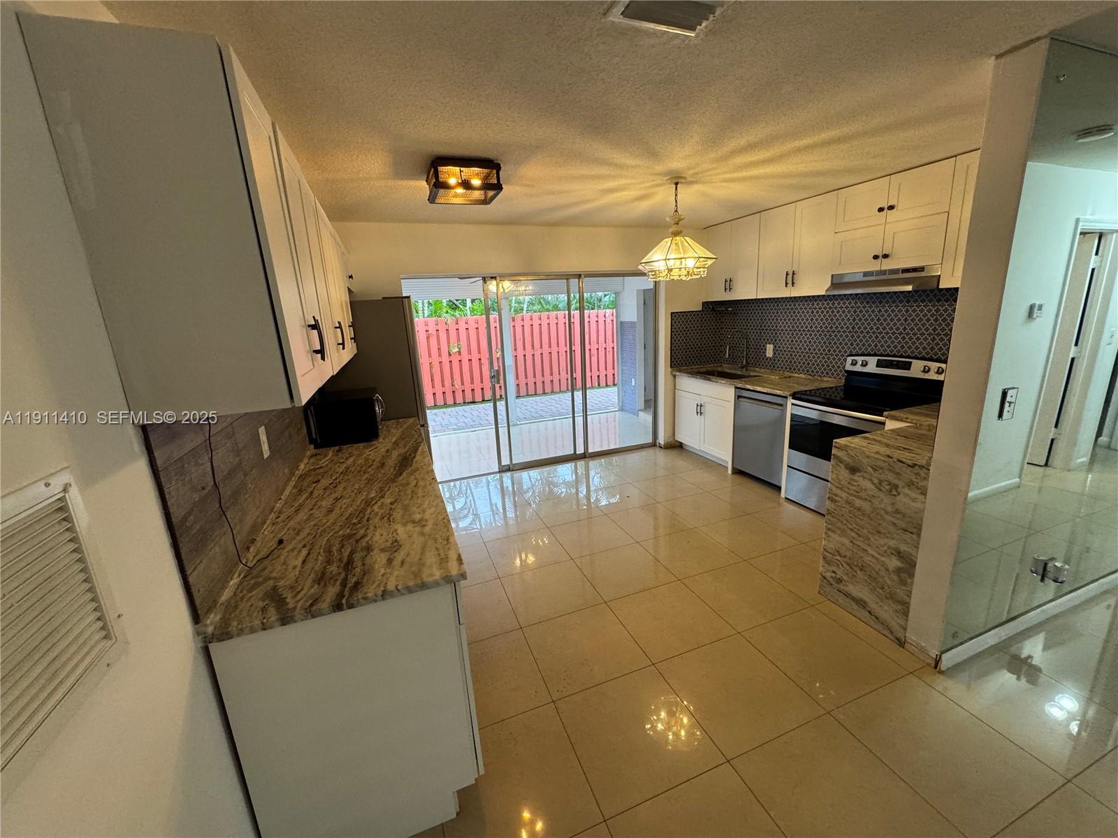 4578 Northwest 16th Avenue, Unit 4578 Tamarac, FL 33309 - Photo 7 of 24 a view of open kitchen with a sink