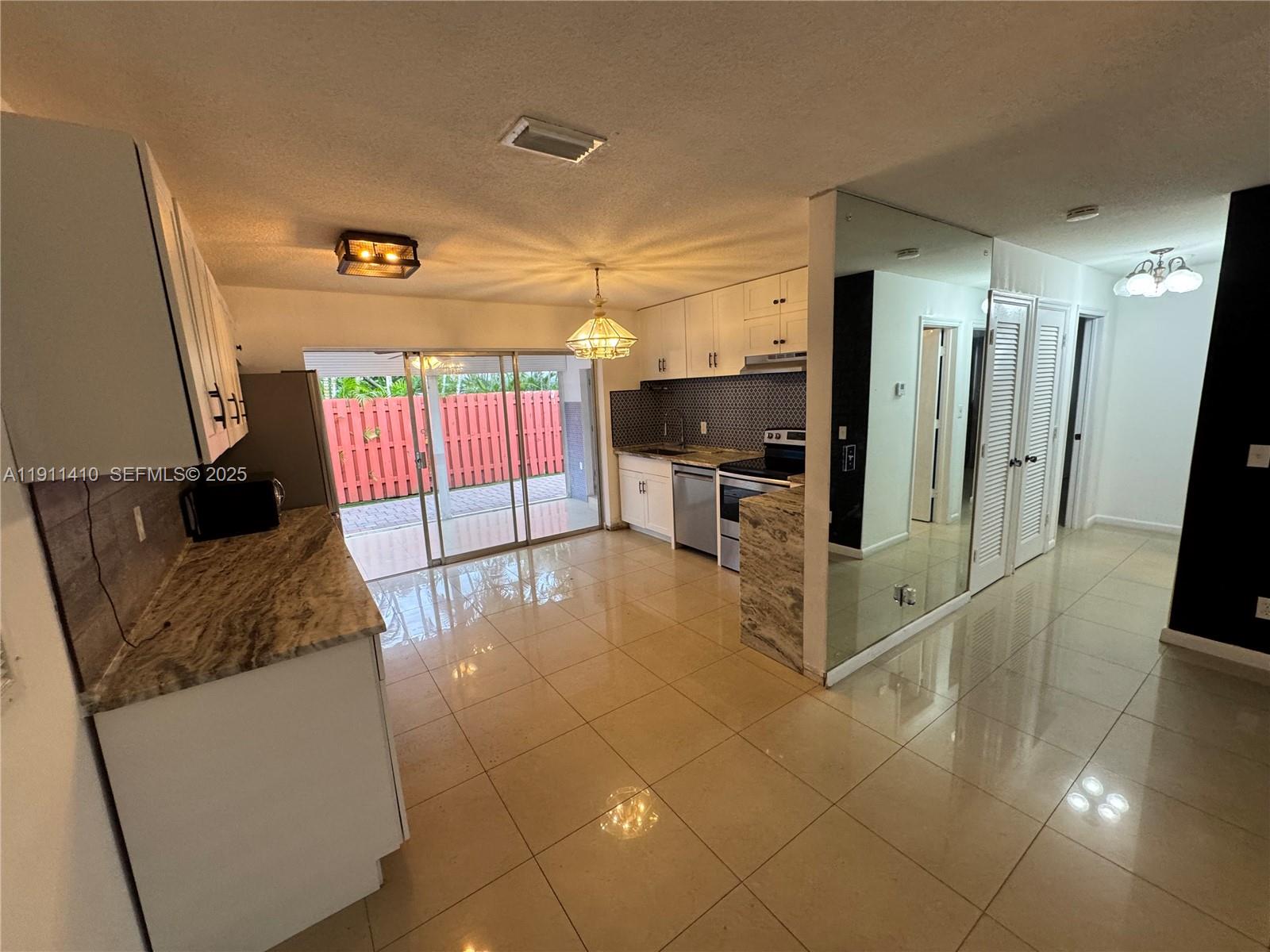 4578 Northwest 16th Avenue, Unit 4578 Tamarac, FL 33309 - Photo 8 of 24 a view of a livingroom with furniture and a flat screen tv