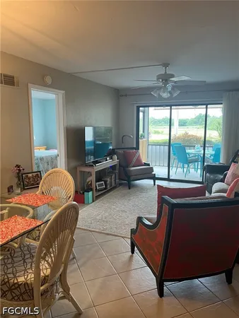 a living room with furniture and a floor to ceiling window