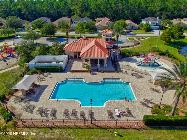 a view of a swimming pool with lounge chairs in patio