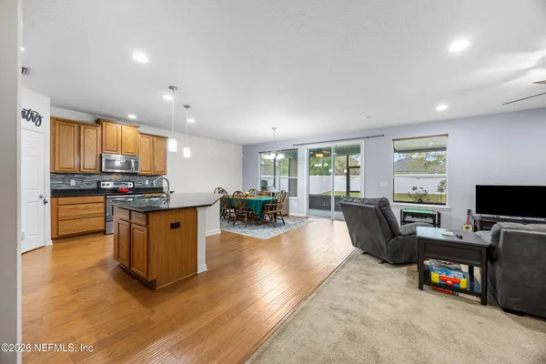a kitchen with sink refrigerator and large window