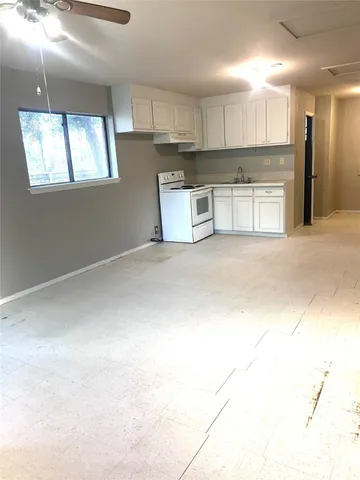a view of a kitchen with a sink and cabinets