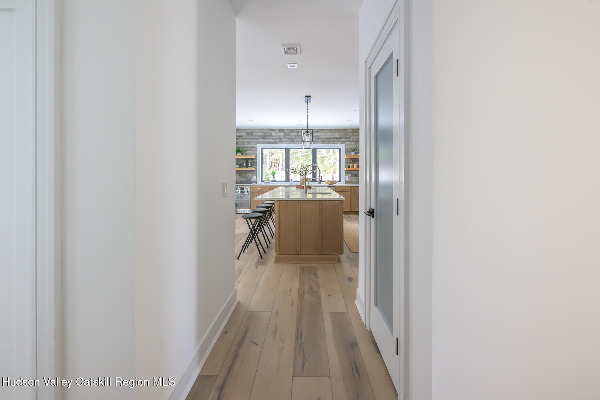 305 Mitchell Hollow Road Windham, NY 12496 - Photo 14 of 39 a view of a hallway with wooden floor and a bathroom