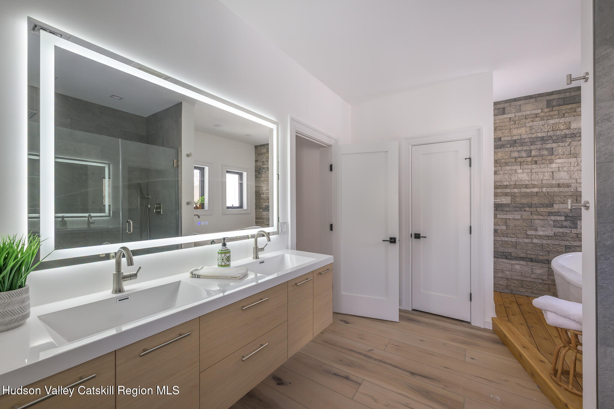 305 Mitchell Hollow Road Windham, NY 12496 - Photo 17 of 39 a bathroom with a double vanity sink and a mirror