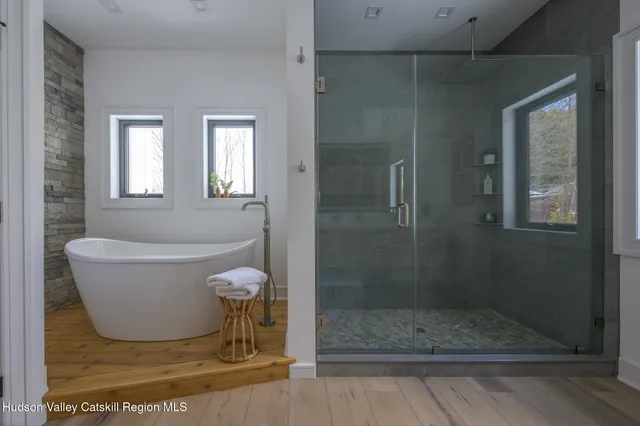 a bathroom with a bathtub and shower
