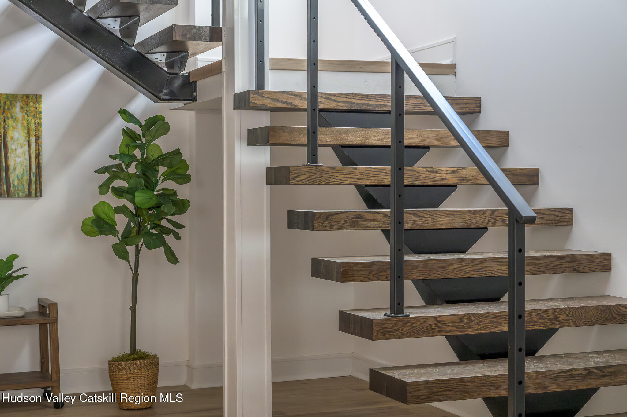 305 Mitchell Hollow Road Windham, NY 12496 - Photo 22 of 39 a view of staircase with wooden floor and a potted plant