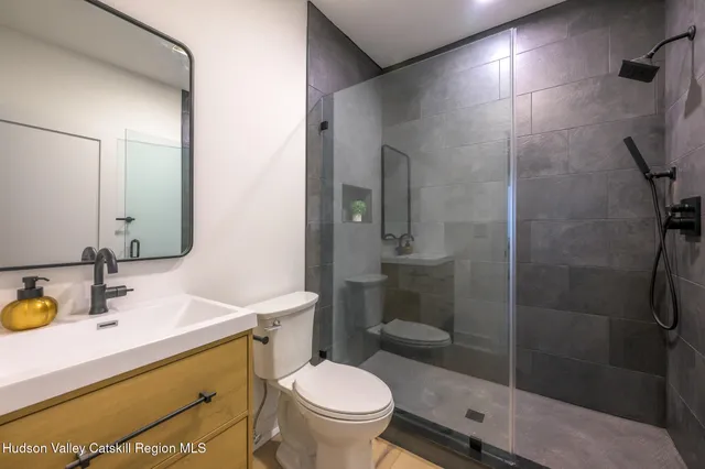 a bathroom with a sink toilet and shower