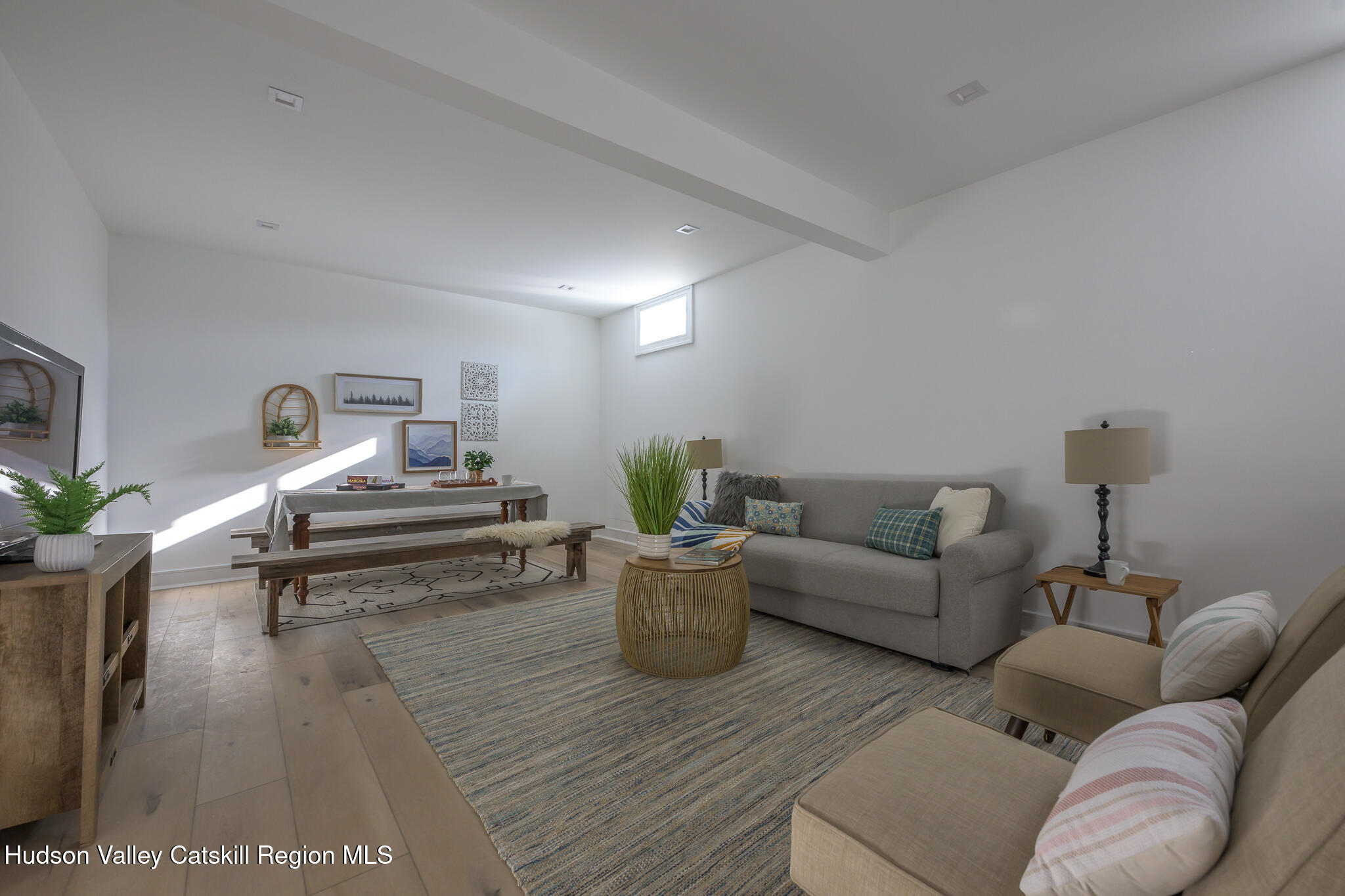 305 Mitchell Hollow Road Windham, NY 12496 - Photo 32 of 39 a living room with furniture and a potted plant on coffee table