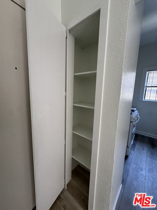 3051 Leeward Avenue, Unit 311 Los Angeles, CA 90005 - Photo 5 of 8 a area with a wooden floor and a hallway